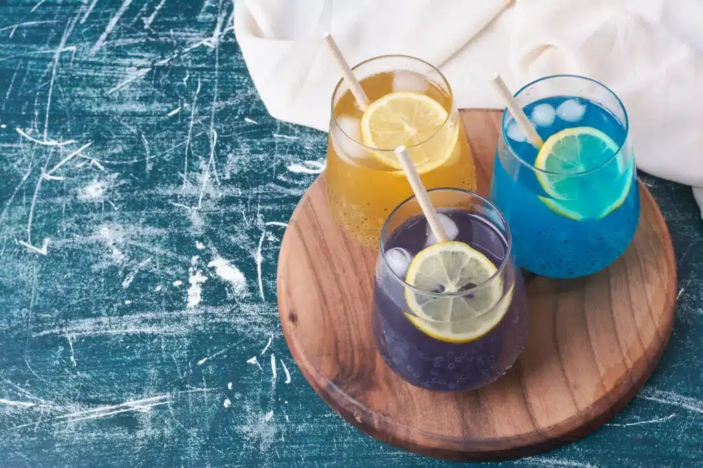 Copy of lemons with colorful cups drink blue